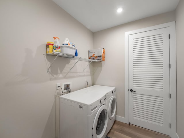 washroom featuring washer and dryer and light hardwood / wood-style flooring