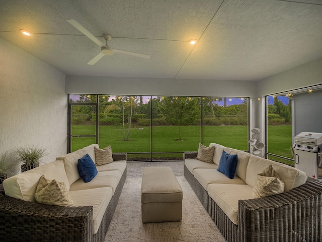 sunroom featuring ceiling fan