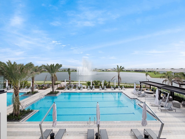 view of swimming pool with a water view and a patio