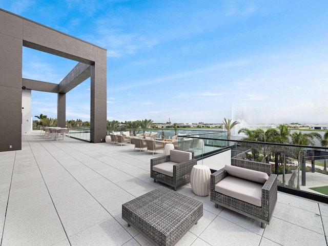 view of patio with an outdoor hangout area and a water view