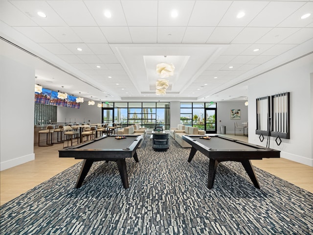 playroom with hardwood / wood-style flooring, indoor bar, and pool table