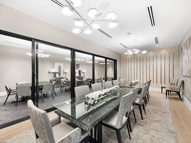 dining room featuring a chandelier and light hardwood / wood-style floors