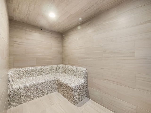 bathroom with tile patterned floors and a shower