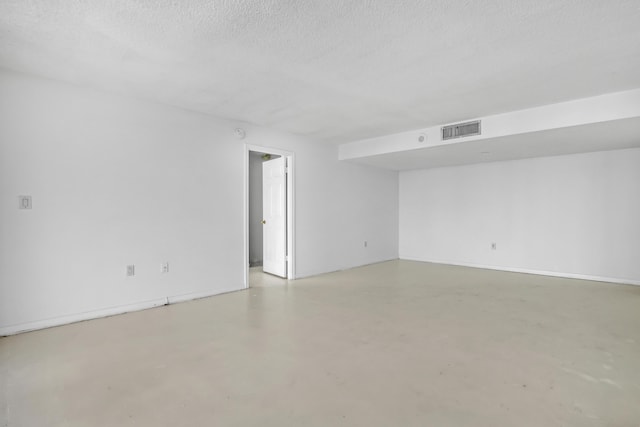 unfurnished room featuring a textured ceiling