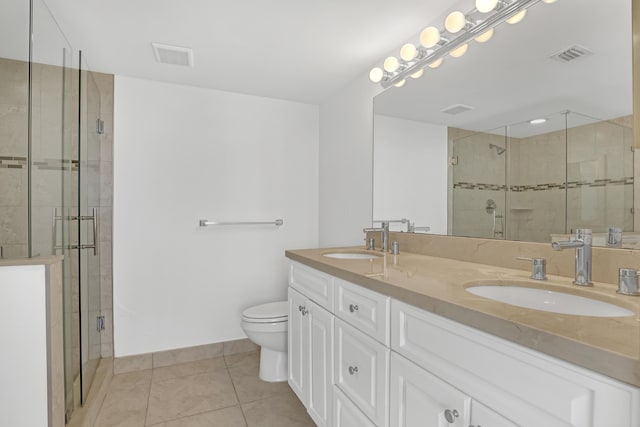 bathroom featuring toilet, tile patterned floors, walk in shower, and vanity