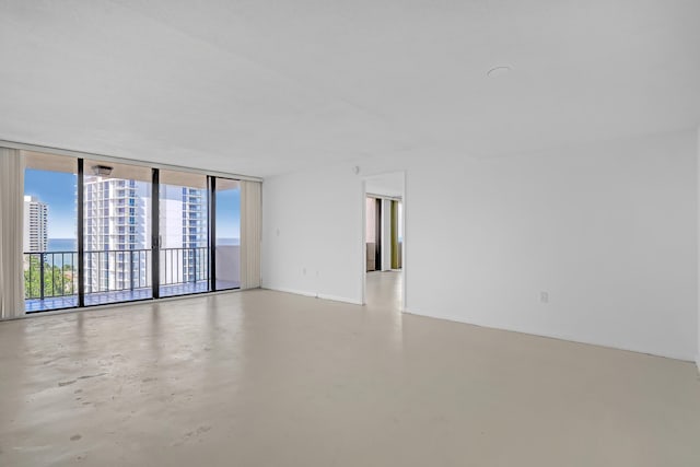 unfurnished room with floor to ceiling windows