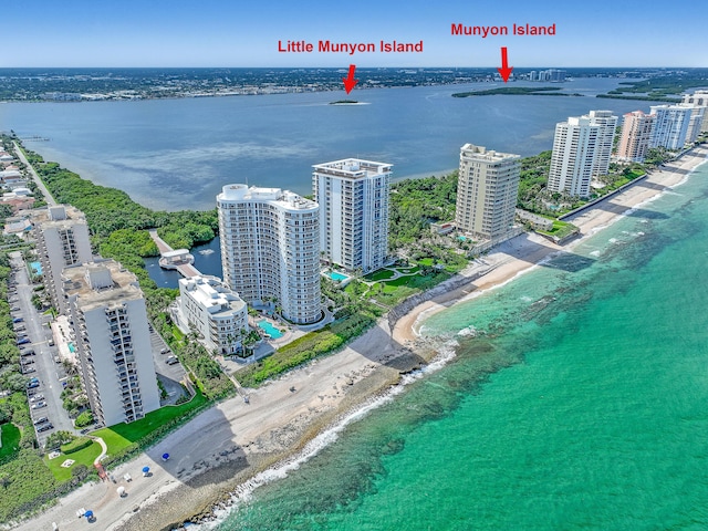 birds eye view of property with a beach view and a water view