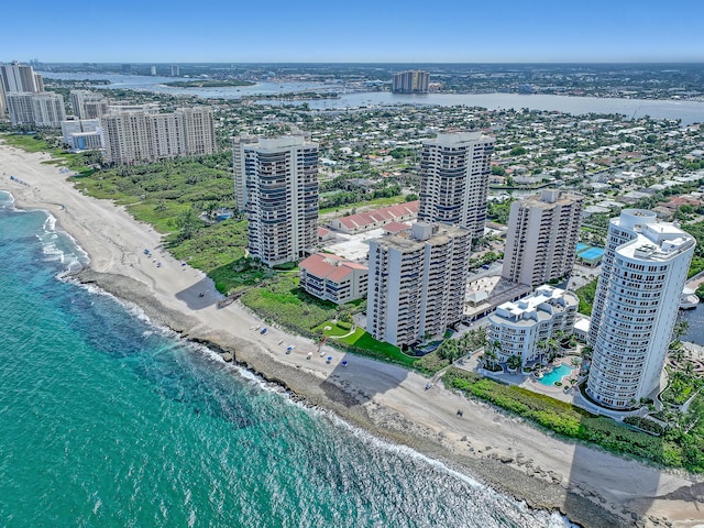 birds eye view of property featuring a water view and a view of the beach