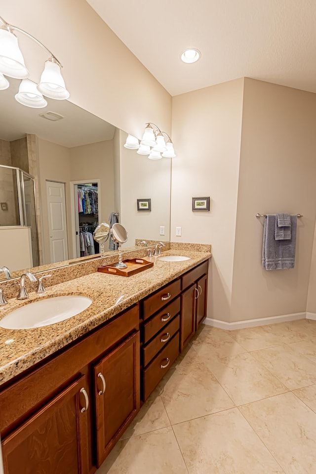 bathroom featuring vanity, an enclosed shower, and tile patterned flooring