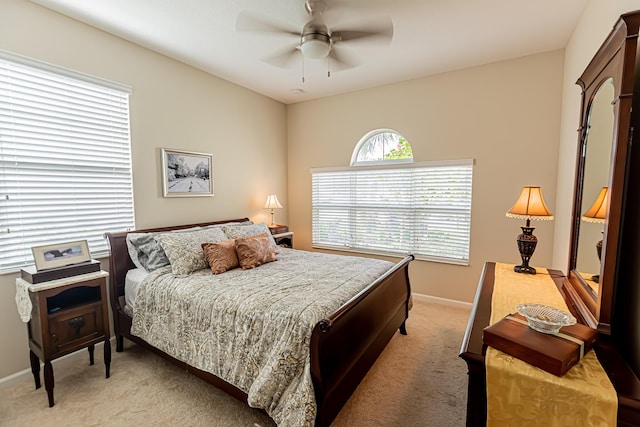 bedroom featuring light carpet and ceiling fan