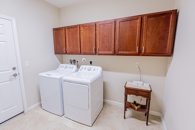 laundry room with cabinets and washer and dryer