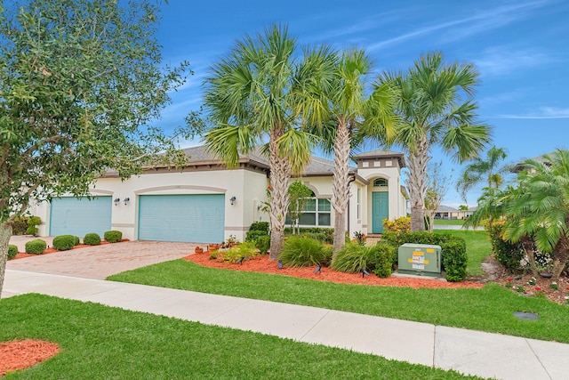 view of front of house with a garage and a front yard