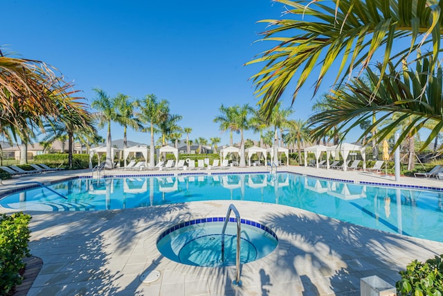 view of pool with a community hot tub and a patio area