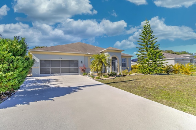 view of front of property with a front yard and a garage