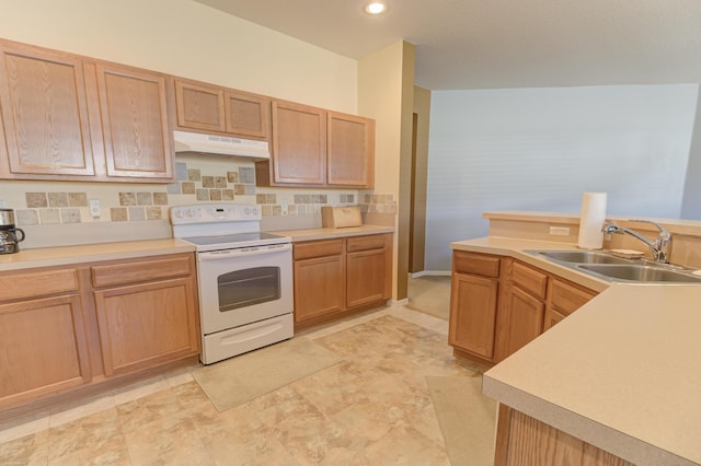 kitchen with white range with electric cooktop, light brown cabinetry, and sink