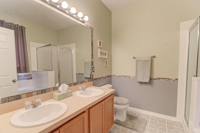 bathroom featuring vanity, tile patterned flooring, a shower with shower door, and toilet