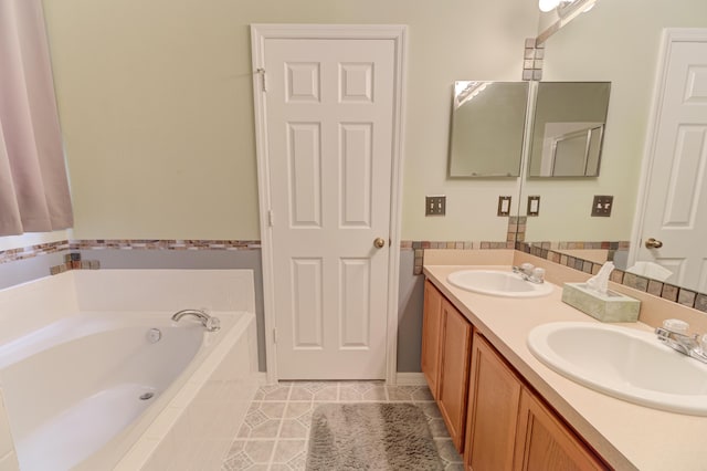 bathroom featuring a relaxing tiled tub, tile patterned floors, and vanity