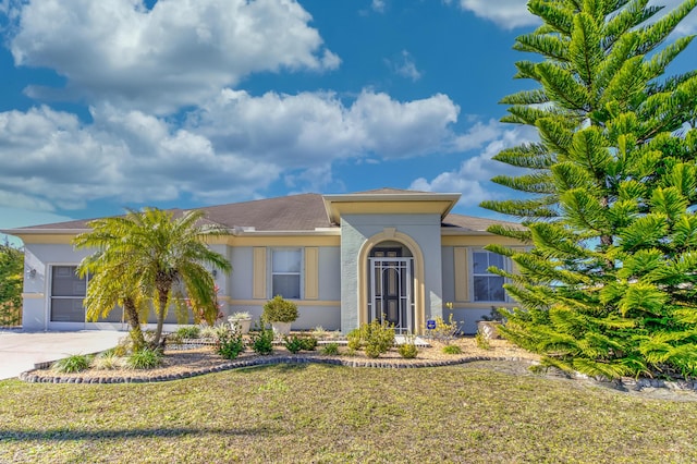 view of front of property featuring a garage and a front lawn