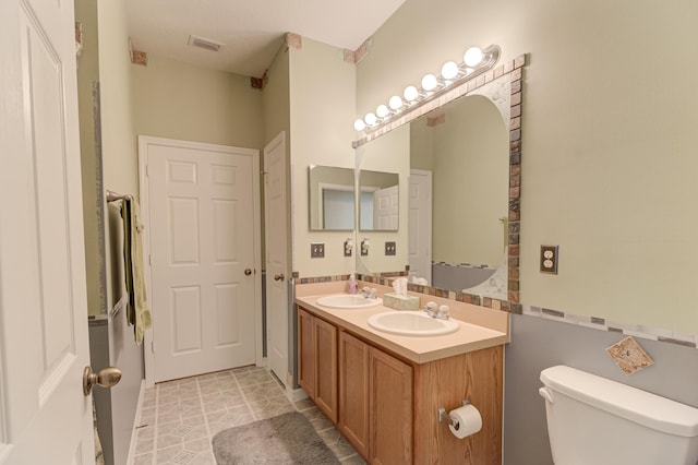 bathroom featuring toilet and vanity