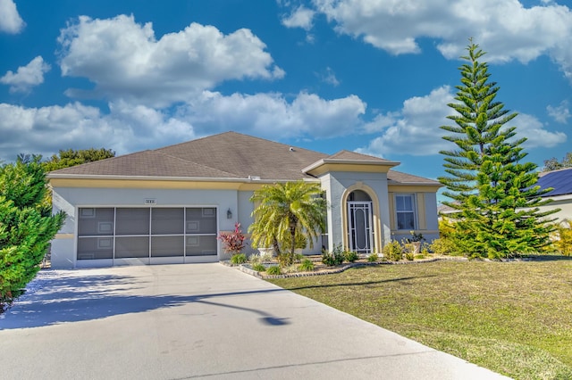 view of front of house with a front lawn and a garage