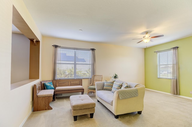 carpeted living room with a healthy amount of sunlight and ceiling fan