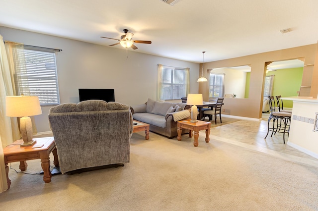 living room with ceiling fan and light carpet