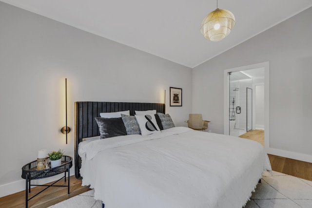 bedroom with lofted ceiling and light wood-type flooring