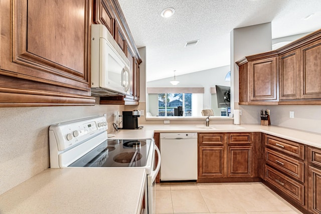 kitchen with white appliances, light tile patterned flooring, a textured ceiling, vaulted ceiling, and sink