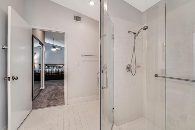 bathroom with vaulted ceiling, ceiling fan, and a shower with door