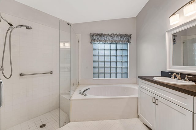 bathroom featuring vanity and shower with separate bathtub