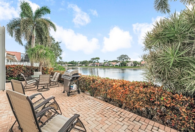 view of patio featuring area for grilling and a water view