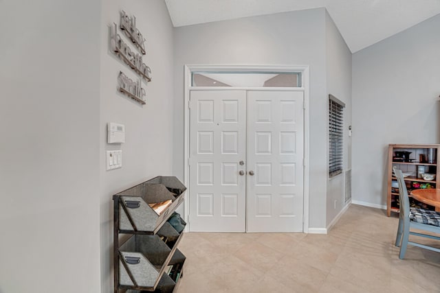 foyer with vaulted ceiling and a textured ceiling