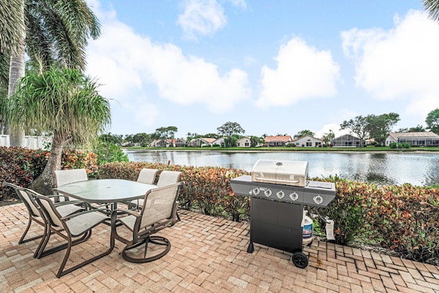 view of patio / terrace with a water view and a grill