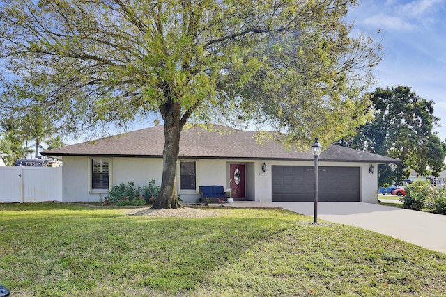 ranch-style home featuring a garage and a front lawn