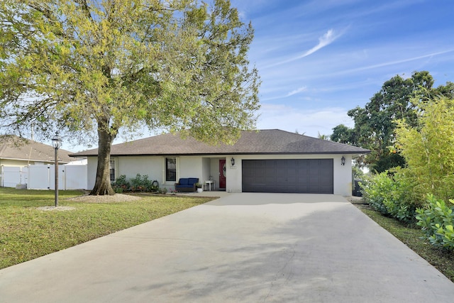 single story home with a garage and a front lawn