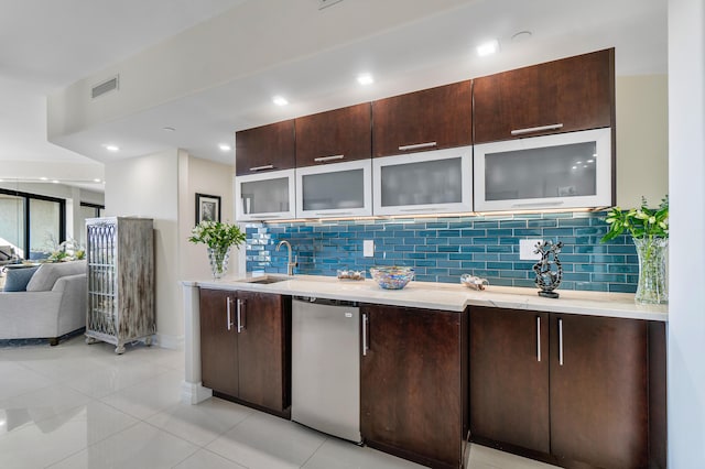 kitchen with light tile patterned flooring, dishwasher, sink, and dark brown cabinets