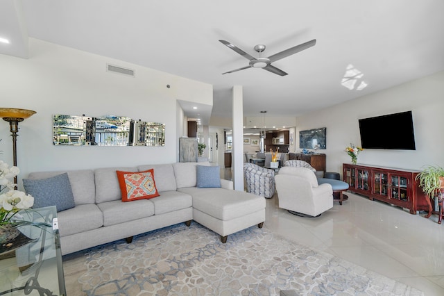 tiled living room featuring ceiling fan