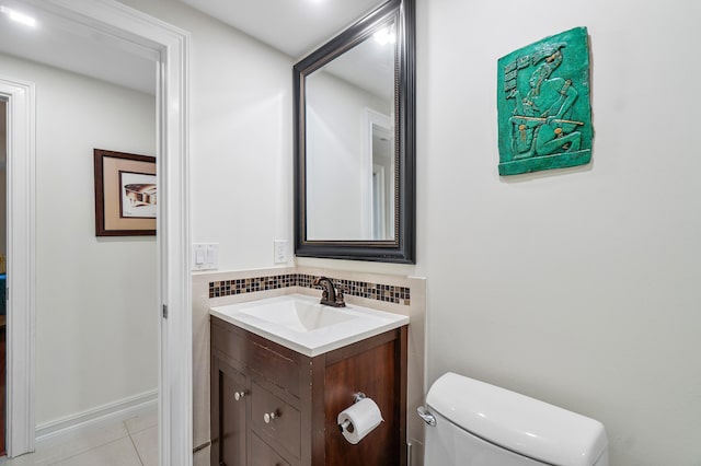 bathroom with vanity, tile patterned floors, backsplash, and toilet