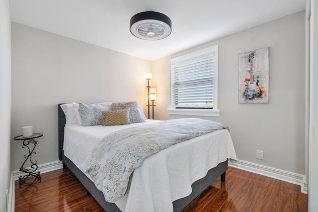 bedroom with dark hardwood / wood-style flooring