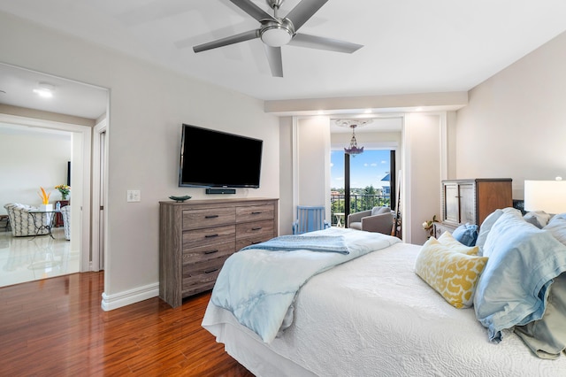 bedroom featuring dark hardwood / wood-style flooring, access to exterior, and ceiling fan