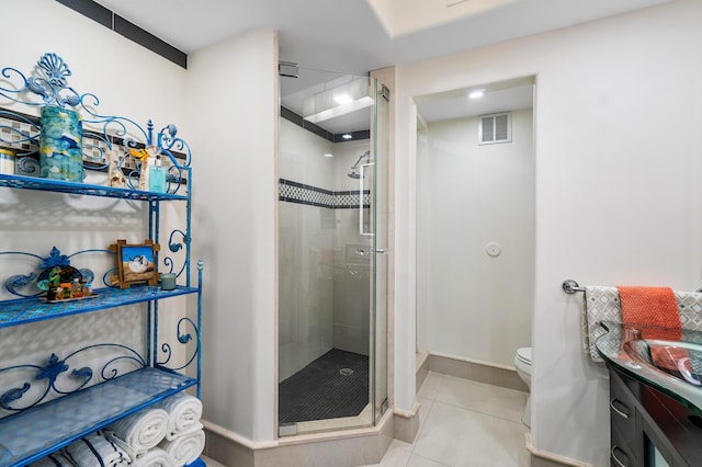 bathroom with tile patterned flooring, sink, an enclosed shower, and toilet