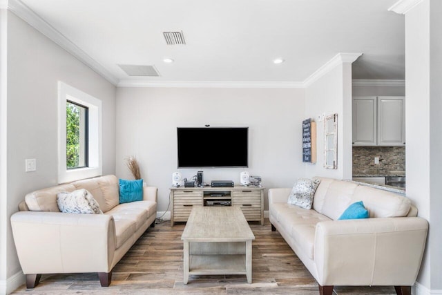 living room featuring crown molding and hardwood / wood-style floors