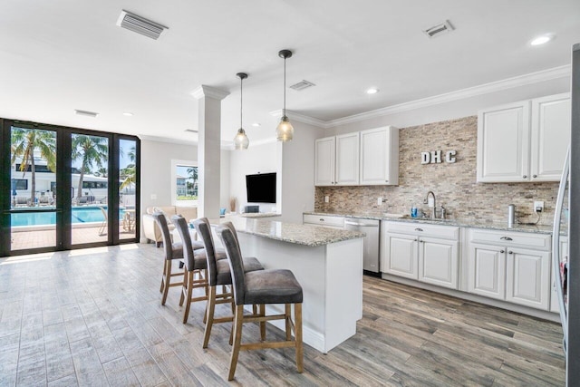 kitchen with white cabinetry, light stone countertops, and appliances with stainless steel finishes