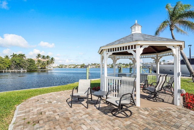 view of patio featuring a gazebo and a water view