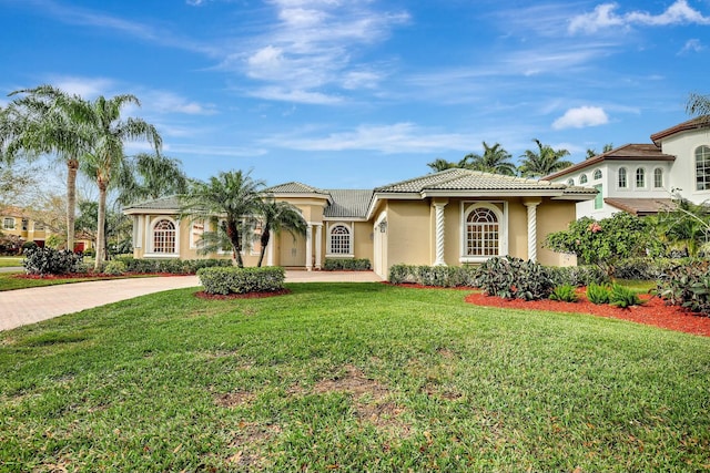 mediterranean / spanish-style house with a front yard