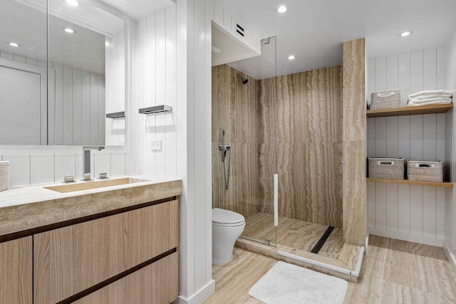 bathroom featuring vanity, toilet, a shower, and wooden walls