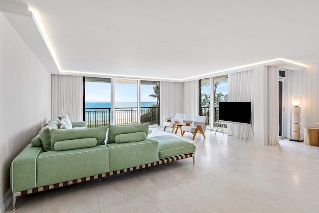 living room with plenty of natural light, a wall of windows, and light tile patterned floors