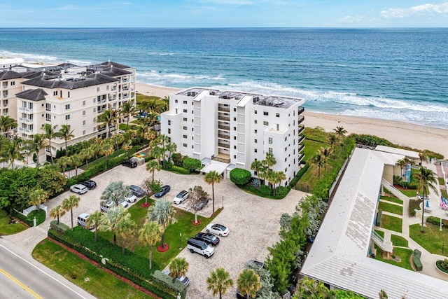 drone / aerial view featuring a beach view and a water view