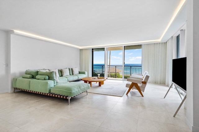 living room featuring light tile patterned floors and a wall of windows