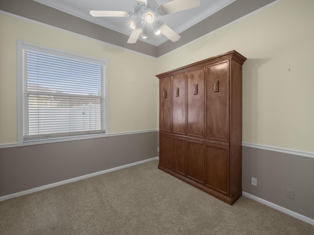 unfurnished bedroom with ornamental molding, ceiling fan, and light colored carpet